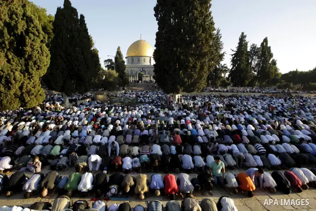 Palestinian men perform the morning Eid Al-Fitr prayer in front of the Dome of Rock at the Al-Aqsa Mosque compound, Islam's thrid most holy site, in Israeli annexed East Jerusalem, on August 30, 2011, marking the end of...