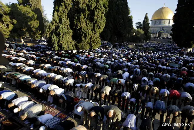 Palestinian men perform the morning Eid Al-Fitr prayer in front of the Dome of Rock at the Al-Aqsa Mosque compound, Islam's thrid most holy site, in Israeli annexed East Jerusalem, on August 30, 2011, marking the end of...