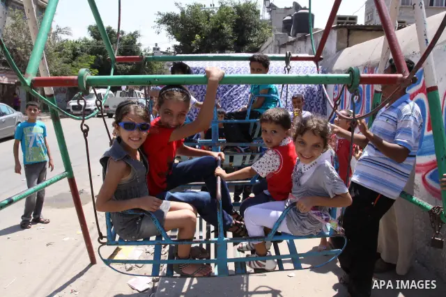 Palestinian children enjoy a ride at an amusement park on the second day of the Eid al-Fitr holiday, which marks the end of the holy fasting month of Ramadan in Gaza City, on August 31 2011. Photo by Mohammed Asad