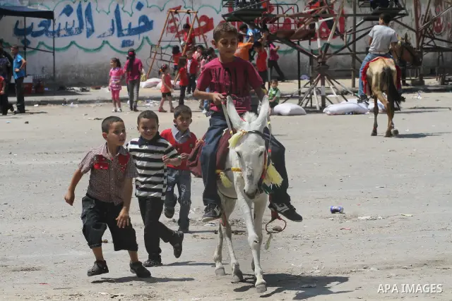 Palestinian children enjoy a ride at an amusement park on the second day of the Eid al-Fitr holiday, which marks the end of the holy fasting month of Ramadan in Gaza City, on August 31 2011. Photo by Mohammed Asad