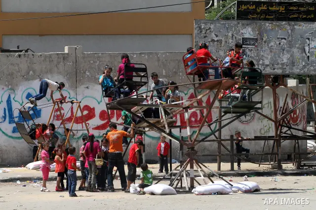 Palestinian children enjoy a ride at an amusement park on the second day of the Eid al-Fitr holiday, which marks the end of the holy fasting month of Ramadan in Gaza City, on August 31 2011. Photo by Mohammed Asad