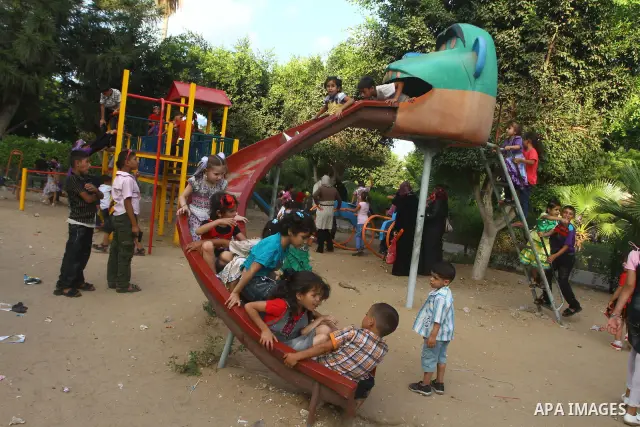 Palestinian children enjoy a ride at an amusement park on the second day of the Eid al-Fitr holiday, which marks the end of the holy fasting month of Ramadan in Gaza City, on August 31 2011. Photo by Ashraf Amra