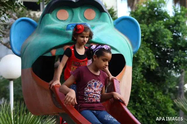Palestinian children enjoy a ride at an amusement park on the second day of the Eid al-Fitr holiday, which marks the end of the holy fasting month of Ramadan in Gaza City, on August 31 2011. Photo by Ashraf Amra