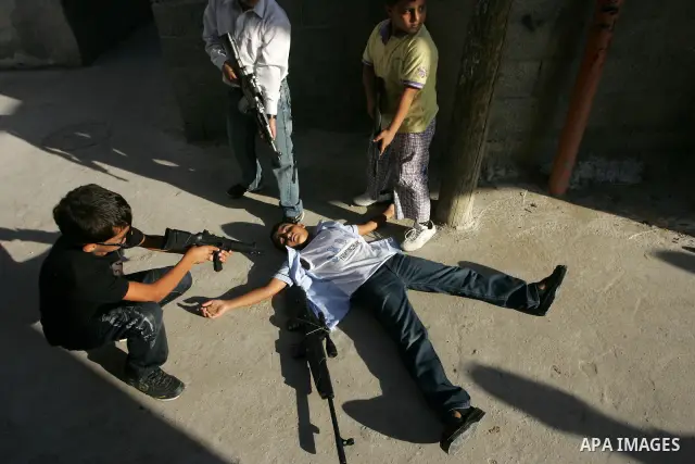 Palestinian boys play with toy guns on the third day of the Eid al-Fitr holiday in Rafah Refugee Camp in the southern Gaza Strip on 01 September 2011. Eid marks the end of the holy month of Ramadan. Photo by Abed Rahim K...