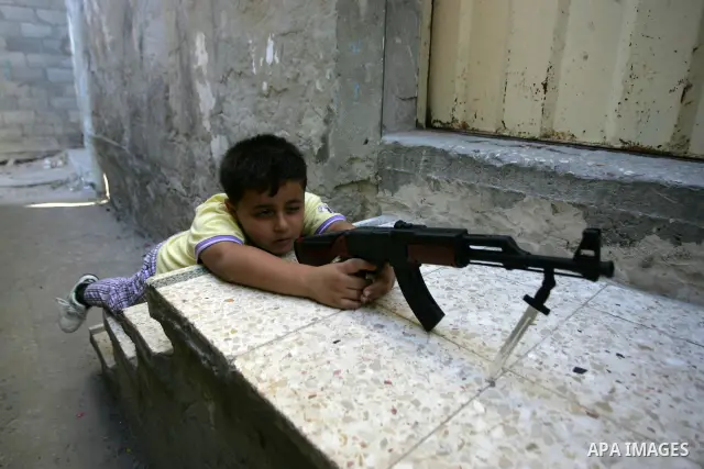 Palestinian boys play with toy guns on the third day of the Eid al-Fitr holiday in Rafah Refugee Camp in the southern Gaza Strip on 01 September 2011. Eid marks the end of the holy month of Ramadan. Photo by Abed Rahim K...