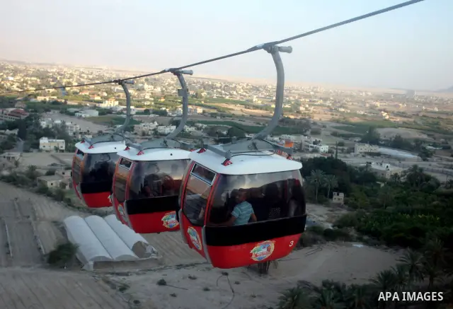 Tourists tour the historic sites of Jericho in cable cars during celebrations on the third day of the Eid al-Fitr holiday, which marks the end of the holy fasting month of Ramadan in the West Bank city of Jericho on Sept...