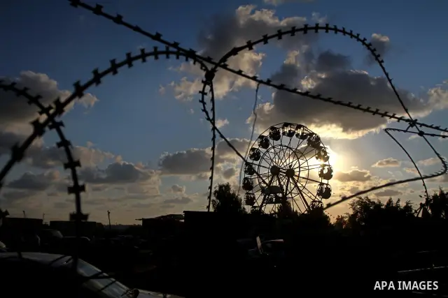 Palestinian children enjoy a ride at an amusement park on the third day of the Eid al-Fitr holiday, which marks the end of the holy fasting month of Ramadan in Gaza city on Sept. 1,2011. Photo by Ashraf Amra