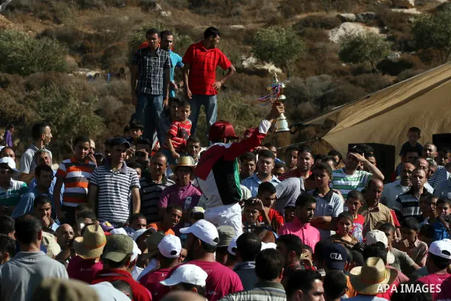 Palestinian jockeys compete during a horse race in the West Bank village of Abu Falah, near the town of Ramallah ,on 02 September 2011. Some 60 horses in different heats participated in races through the day, attracting...