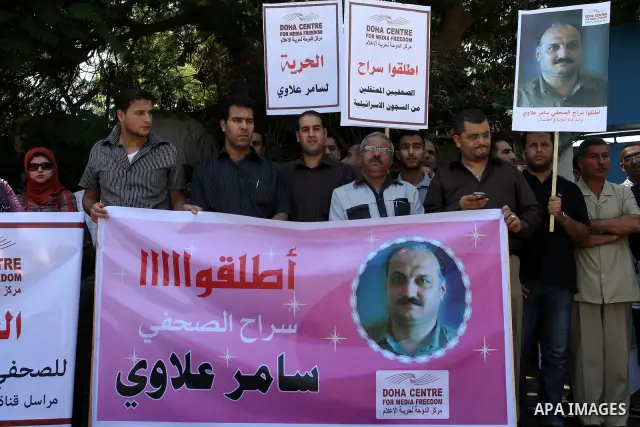Palestinian journalists take part in a protest in support with the journalist, Samir Allawi, Al-Jazeera correspondent in Afghanistan and his fellow journalists detained in Israeli prisons, infront of UNRWA headquarters i...