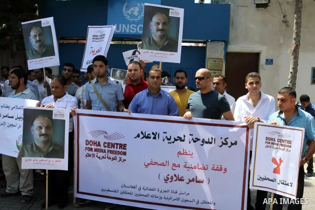 Palestinian journalists take part in a protest in support with the journalist, Samir Allawi, Al-Jazeera correspondent in Afghanistan and his fellow journalists detained in Israeli prisons, infront of UNRWA headquarters i...