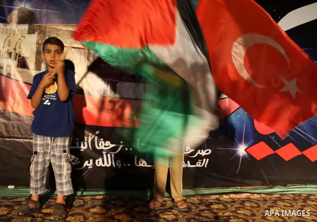 Palestinians wave with their national flag and Turkish flag during a rally in support to Turkish decision in Gaza city on Sep. 3,2011. Turkey said Friday it was expelling the Israeli ambassador and cutting military ties...