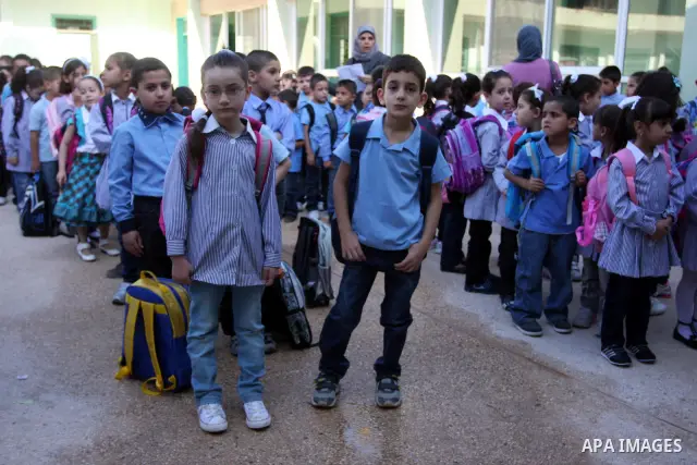 Palestinian students return back to their school in the morning of the first day of the new year study in the West Bank city of Ramallah on Sep. 4, 2011. Photo by Issam Rimawi
