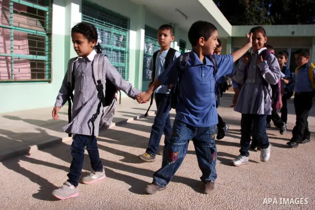 Palestinian students return back to their school in the morning of the first day of the new year study in the West Bank city of Ramallah on Sep. 4, 2011. Photo by Issam Rimawi