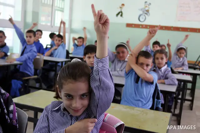 Palestinian students return back to their school in the morning of the first day of the new year study in the West Bank city of Ramallah on Sep. 4, 2011. Photo by Issam Rimawi