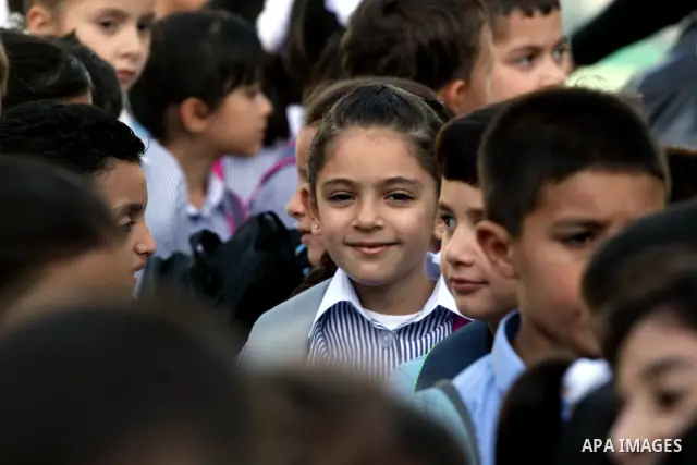 Palestinian students return back to their school in the morning of the first day of the new year study in the West Bank city of Ramallah on Sep. 4, 2011. Photo by Issam Rimawi
