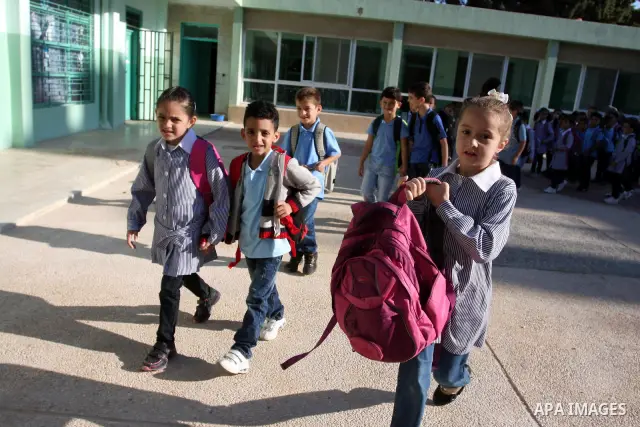 Palestinian students return back to their school in the morning of the first day of the new year study in the West Bank city of Ramallah on Sep. 4, 2011. Photo by Issam Rimawi