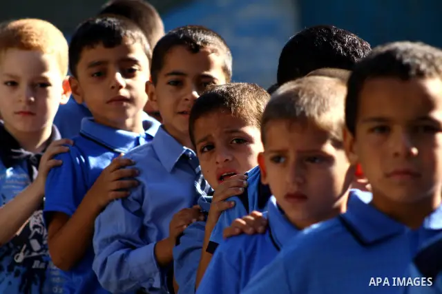 Palestinian students return back to their school in the morning of the first day of the new year study in Gaza city on Sep. 4, 2011. Photo by Ashraf Amra