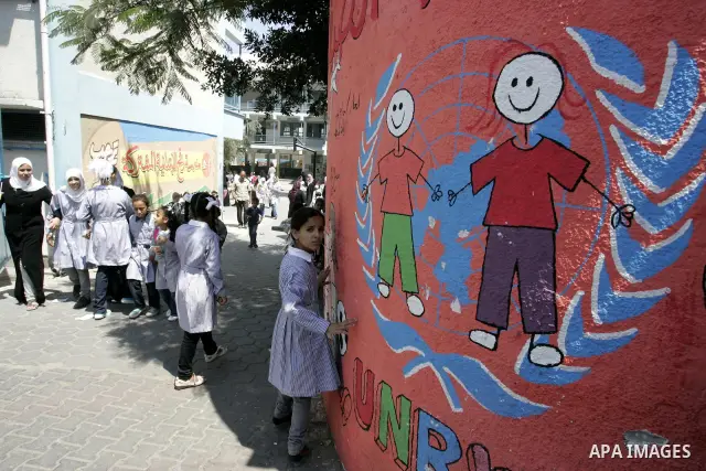 Palestinian students return back to their school in the morning of the first day of the new year study in Rafah, southern Gaza Strip on Sep. 4, 2011. Photo by Abed Rahim Khatib