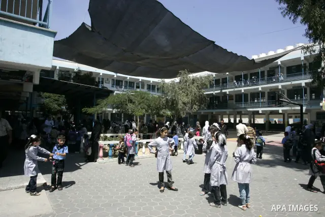 Palestinian students return back to their school in the morning of the first day of the new year study in Rafah, southern Gaza Strip on Sep. 4, 2011. Photo by Abed Rahim Khatib