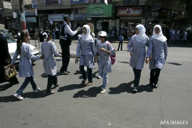 Palestinian students return back to their school in the morning of the first day of the new year study in Rafah, southern Gaza Strip on Sep. 4, 2011. Photo by Abed Rahim Khatib