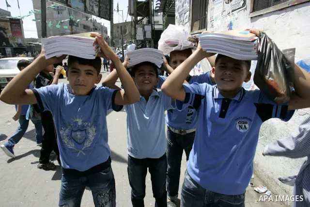 Palestinian students return back to their school in the morning of the first day of the new year study in Rafah, southern Gaza Strip on Sep. 4, 2011. Photo by Abed Rahim Khatib