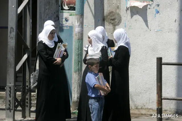 Palestinian students return back to their school in the morning of the first day of the new year study in Rafah, southern Gaza Strip on Sep. 4, 2011. Photo by Abed Rahim Khatib