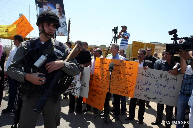 Palestinian activists take part in a protest calling for the release of the Palestinian journalist, Samer Allawi in the West Bank city of Ramallah, Sept. 4, 2011. Allawi, the chief of al-Jazeera TV bureau in Afghanistan,...