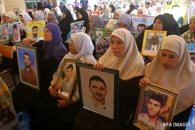Palestinian women hold pictures of their prisoned relatives in Israeli jails as they gather in a weekly activity calling for their liberty at the Red Cross headquarters in Gaza City onSep. 5, 2011. About 7000 prisoners a...
