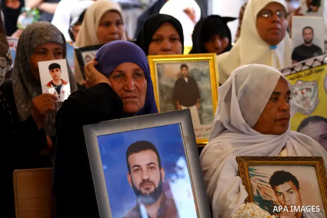 Palestinian women hold pictures of their prisoned relatives in Israeli jails as they gather in a weekly activity calling for their liberty at the Red Cross headquarters in Gaza City onSep. 5, 2011. About 7000 prisoners a...