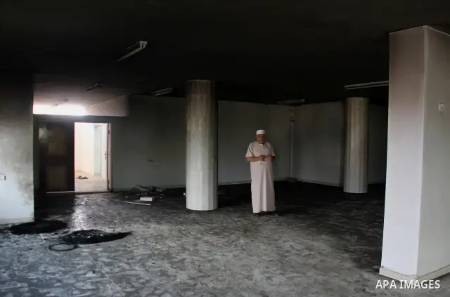 A Palestinian man stands inside a damaged mosque in the West Bank village of Qusra, near Nablus September 5, 2011. Jewish settlers set fire to part of the mosque in the occupied West Bank on Monday, Palestinians said, an...