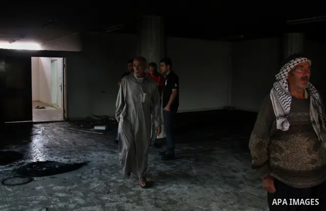 Palestinians inspect the damage inside a mosque torched and vandalized by arsonists in the West Bank village of Qusra, near Nablus, on Sept. 5, 2011. Arsonists tossed tow tires into the first floor study hall of a new mo...