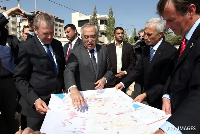 Palestinian Prime Minister Salam Fayyad and his Belgian counterpart, Yves Leterme visit the area C, in the West Bank town of Ramallah, on 05 September 2011, a day after Palestinian officials insisted they would not drop...