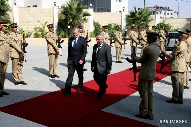 Palestinian Prime Minister Salam Fayyad reviews an honour guard with his Belgian counterpart Yves Leterme upon the latter's arrival in the West Bank city of Ramallah on September 5, 2011, a day after Palestinian official...