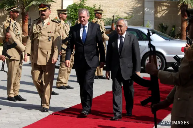 Palestinian Prime Minister Salam Fayyad reviews an honour guard with his Belgian counterpart Yves Leterme upon the latter's arrival in the West Bank city of Ramallah on September 5, 2011, a day after Palestinian official...