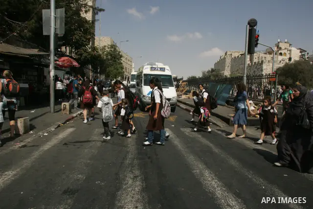 Palestinian students walk in a street after they returned back from their school on the second day of the new studing year, in Jerusalem's old city on Sep. 5,2011. Photo by Mahfouz Abu Turk