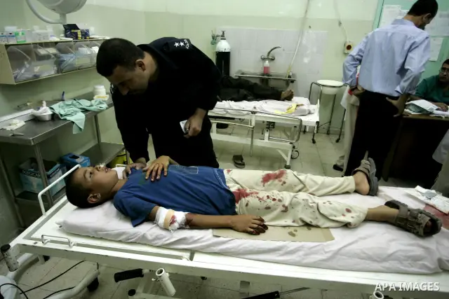 A wounded Palestinian boy receives medical care on September 6, 2011 at a hospital in Khan Yunis, following an Israeli air strike east of the central Gaza Strip city in which a Palestinian militant was killed and three c...