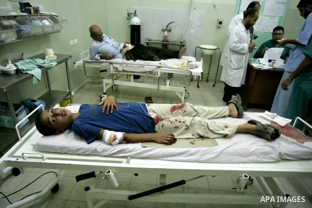 A wounded Palestinian father and his son receive medical care on September 6, 2011 at a hospital in Khan Yunis, following an Israeli air strike east of the central Gaza Strip city in which a Palestinian militant was kill...