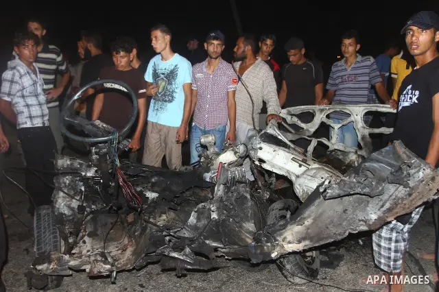 Palestinians check the damage to a car after an Israeli attack in Deir al-Balah in the central Gaza Strip on September 7, 2011. The hardline Islamic Jihad group said that the dead man, Remah al-Hasani, was a member of it...