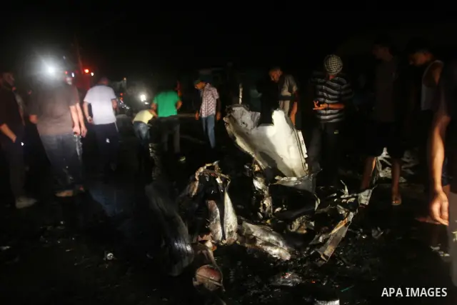 Palestinians check the damage to a car after an Israeli attack in Deir al-Balah in the central Gaza Strip on September 7, 2011. The hardline Islamic Jihad group said that the dead man, Remah al-Hasani, was a member of it...