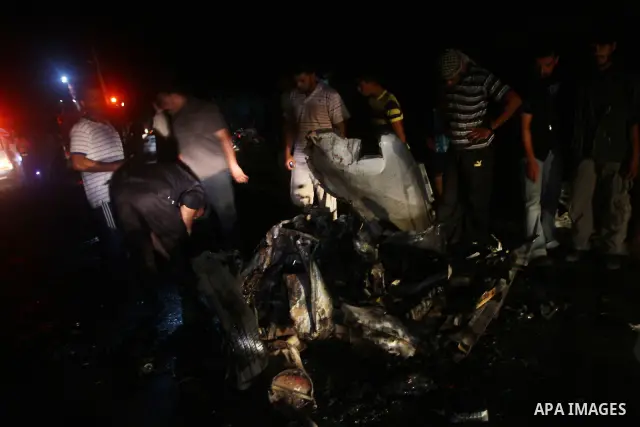 Palestinians check the damage to a car after an Israeli attack in Deir al-Balah in the central Gaza Strip on September 7, 2011. The hardline Islamic Jihad group said that the dead man, Remah al-Hasani, was a member of it...