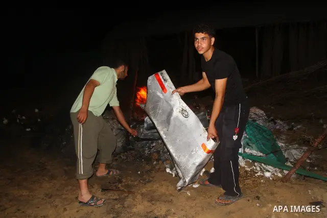Palestinians check the damage to a car after an Israeli attack in Deir al-Balah in the central Gaza Strip on September 7, 2011. The hardline Islamic Jihad group said that the dead man, Remah al-Hasani, was a member of it...