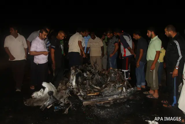 Palestinians check the damage to a car after an Israeli attack in Deir al-Balah in the central Gaza Strip on September 7, 2011. The hardline Islamic Jihad group said that the dead man, Remah al-Hasani, was a member of it...