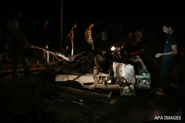 Palestinians check the damage to a car after an Israeli attack in Deir al-Balah in the central Gaza Strip on September 7, 2011. The hardline Islamic Jihad group said that the dead man, Remah al-Hasani, was a member of it...