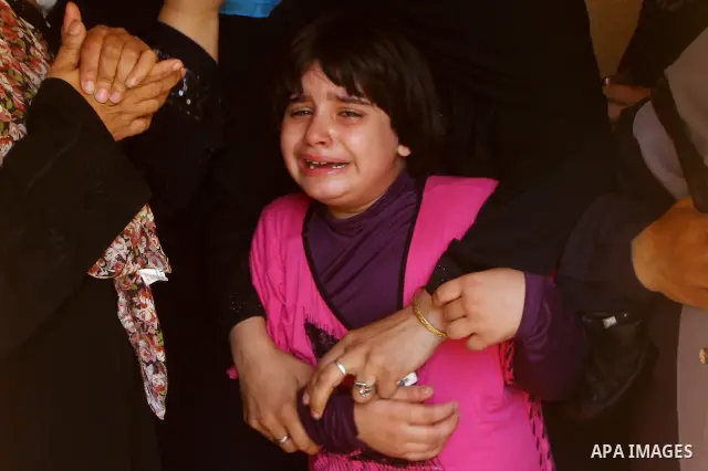 Daughter and relatives of the Palestinian member of its military wing the Al-Quds Brigades, Remah al-Hasani, mourn during his funeral in Gaza city on Sep. 8, 2011. He was killed as he was driving in the central Deir al-B...