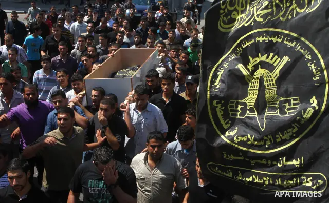 Palestinian mourners carry the body of Remah al-Hasani, a member of its military wing, the Al-Quds Brigades, during his funeral in Gaza city on Sep. 8, 2011. He was killed as he was driving in the central Deir al-Balah d...