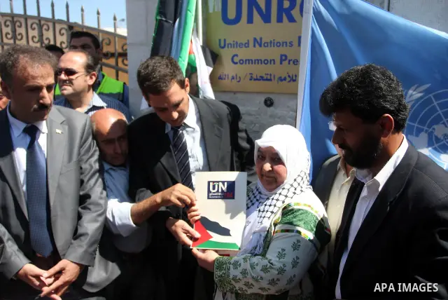 Palestinian activist Latifa Abu Hmeid delivers a letter addressed to the UN Secretary-General Ban Ki-moon to Pascale Soto, a UN officer in the West Bank city of Ramallah, on Sep. 8, 2011. The Palestinians on Thursday off...