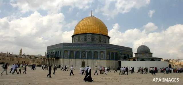 Palestinians walk in front of the Dome of the Rock after Friday prayers at the Al-Aqsa mosque compound in Jerusalem's old city on Sep. 9,2011. Photo by Mahfouz Abu Turk