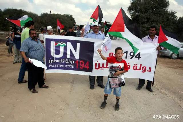 Palestinians wave flags during a demonstration in the West Bank town of Bilin, near Ramallah, Friday, Sept. 9, 2011. The Palestinians have launched a campaign to rally support for U.N. recognition as an independent state...