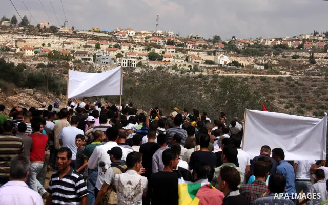 Palestinians march towards the gate of Qadomim during the weekly protest against the settlement of Qadomim, near the village of Kofr Qadom, west of Nablus City, in the Israeli-occupied West Bank on 09 September 2011. Pho...