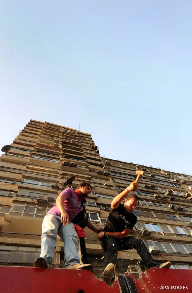 Egyptian protesters dismantle the concrete wall which was built in front of the Israeli embassy, in Cairo, Egypt, 09 September 2011. Security forces had built the wall in an attempt to secure the embassy after a series o...